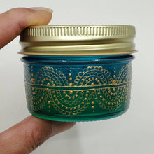 Load image into Gallery viewer, Hand Stained - Hand Painted wide mouth glass jar - blue fading to green (ombre) with intricate gold (henna style) designs. Boho