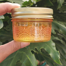 Load image into Gallery viewer, Hand Stained - Hand Painted wide mouth glass jar - yellow fading to orange (ombre) with intricate gold (henna style) designs. Boho