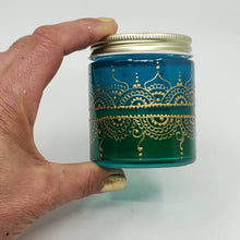 Load image into Gallery viewer, Hand Stained-Painted glass jar- green fading to blue (ombre) with intricate gold (henna style) designs. Bohemian centerpiece