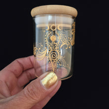 Load image into Gallery viewer, Stash Jar. Hand painted glass jar with sacred Goddess and moon cycles painted in gold. Airtight, straight sided, portable herb jar
