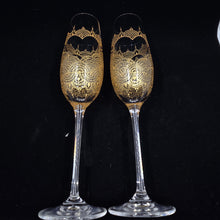 Load image into Gallery viewer, Wedding glasses for the bride with customized names, hand painted in a heart with gold on a champagne flute. Personalized toasting glasses.