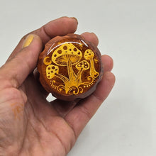 Load image into Gallery viewer, Small 4 part Herb Grinder with Kief catcher. Hand painted gold mushrooms on imitation wood. Sharp teeth, magnetic closure with smooth grinding
