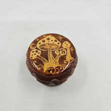 Load image into Gallery viewer, Small 4 part Herb Grinder with Kief catcher. Hand painted gold mushrooms on imitation wood. Sharp teeth, magnetic closure with smooth grinding
