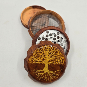 Medium size 4 part Herb Grinder with pollen catcher. Hand painted tree of life on imitation wood. Sharp teeth, magnetic closure with smooth grinding