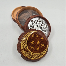 Load image into Gallery viewer, Medium size 4 part Herb Grinder with Kief catcher. Hand painted Moon on imitation wood. Sharp teeth, magnetic closure with smooth grinding
