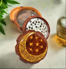 Load image into Gallery viewer, Medium size 4 part Herb Grinder with Kief catcher. Hand painted Moon on imitation wood. Sharp teeth, magnetic closure with smooth grinding
