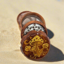 Load image into Gallery viewer, Medium size 4 part Herb Grinder with Kief catcher. Hand painted mushrooms on imitation wood. Sharp teeth, magnetic closure with smooth grinding
