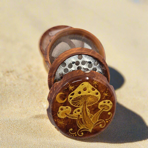 Medium size 4 part Herb Grinder with Kief catcher. Hand painted mushrooms on imitation wood. Sharp teeth, magnetic closure with smooth grinding