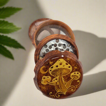 Load image into Gallery viewer, Medium size 4 part Herb Grinder with Kief catcher. Hand painted mushrooms on imitation wood. Sharp teeth, magnetic closure with smooth grinding
