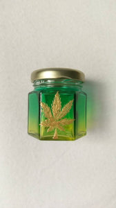 Hand Stained-Painted glass nug jar- yellow fading to green( ombre) with a pot leaf painted on top in gold paint.