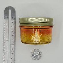 Load image into Gallery viewer, Hand Stained - Hand Painted glass nug jar - Wide Mouth! orange fading to yellow (Ombre) with gold marijuana leaves and swirls . Boho
