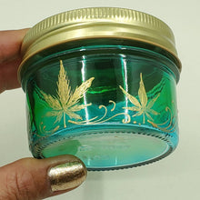 Load image into Gallery viewer, Hand Stained - Hand Painted glass nug jar - Wide Mouth! Green fading to blue (Ombre) with gold marijuana leaves and swirls . Boho
