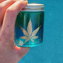 Load image into Gallery viewer, Hand Stained - Hand Painted glass nug jar - blue fading to green (Ombre) with gold marijuana leaves and swirls . Boho
