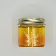 Load image into Gallery viewer, Hand Stained-Painted glass stash jar - orange fading to yellow (ombre) with weed leaf painted in gold

