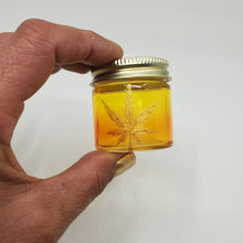 Load image into Gallery viewer, Hand Stained-Painted glass stash jar - orange fading to yellow (ombre) with weed leaf painted in gold
