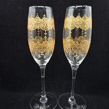 Load image into Gallery viewer, Hand Painted crystal champagne glass/ flute- intricate henna inspired art in Gold wrapping all around the glass.
