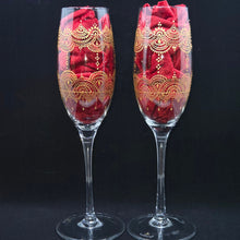 Load image into Gallery viewer, Hand Painted crystal champagne glass/ flute- intricate henna inspired art in Gold wrapping all around the glass.
