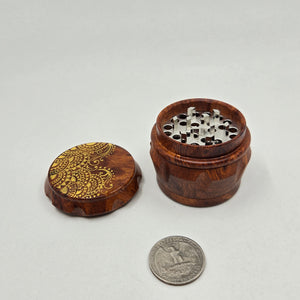 Small 4 part Herb Grinder with Kief catcher. Hand painted henna designs on imitation wood. Sharp teeth, magnetic closure with smooth grinding