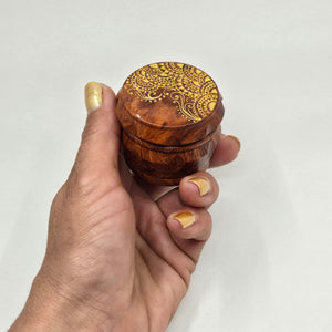 Small 4 part Herb Grinder with Kief catcher. Hand painted henna designs on imitation wood. Sharp teeth, magnetic closure with smooth grinding