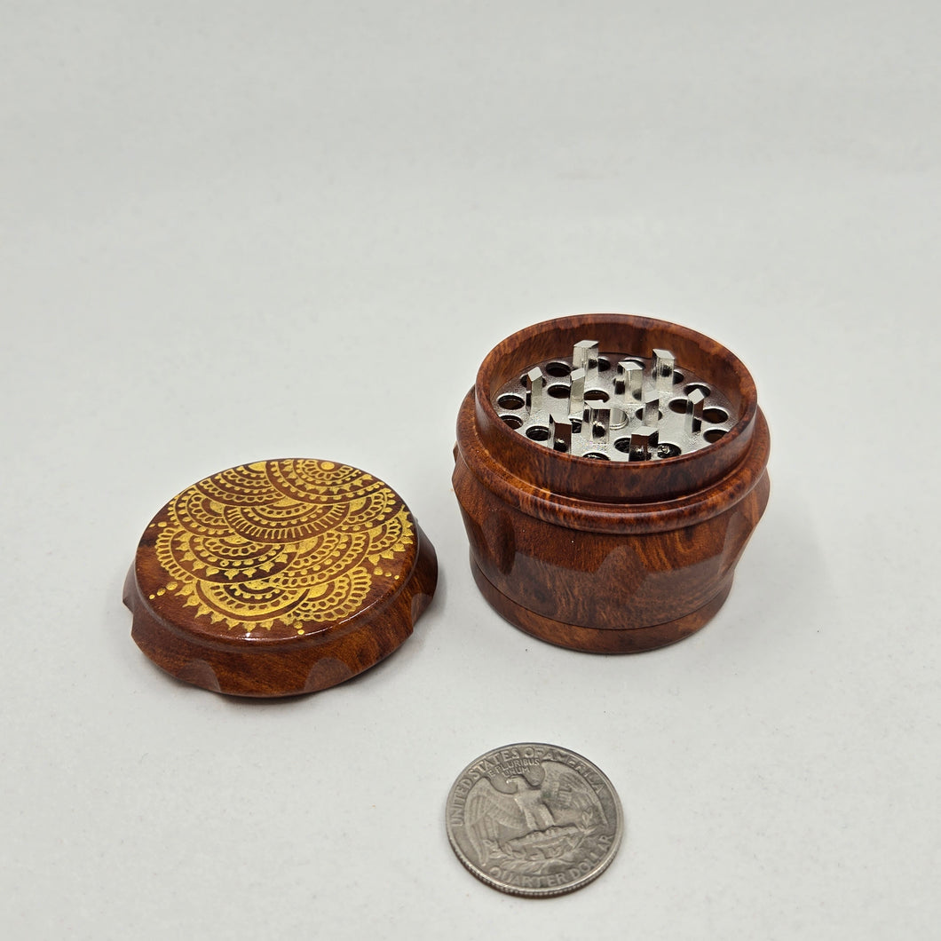 Small 4 part Herb Grinder with Kief catcher. Hand painted henna designs on imitation wood. Sharp teeth, magnetic closure with smooth grinding