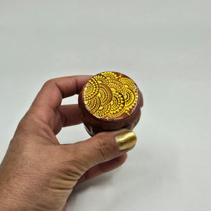 Small 4 part Herb Grinder with Kief catcher. Hand painted henna designs on imitation wood. Sharp teeth, magnetic closure with smooth grinding