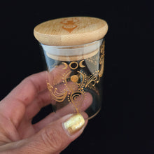 Load image into Gallery viewer, Stash Jar. Hand painted glass jar with sacred Goddess and moon cycles painted in gold. Airtight, straight sided, portable herb jar
