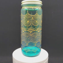Load and play video in Gallery viewer, Hand Stained-Painted glass jar- green fading to blue(ombre) with intricate gold henna style designs
