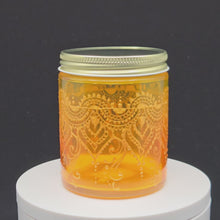 Load and play video in Gallery viewer, Hand Stained - Hand Painted glass jar - orange fading to yellow (ombre) with intricate gold (henna style) designs.
