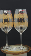 Load and play video in Gallery viewer, Hand Painted Riedel crystal wine glasses - intricate henna inspired art in Gold.
