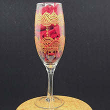Load and play video in Gallery viewer, Hand Painted crystal champagne glass/ flute- intricate henna inspired art in Gold wrapping all around the glass.
