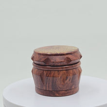 Load and play video in Gallery viewer, Small 4 part Herb Grinder with Kief catcher. Hand painted henna designs on imitation wood. Sharp teeth, magnetic closure with smooth grinding
