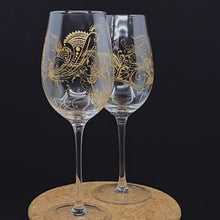 Load and play video in Gallery viewer, Hand Painted Crystal wine glass. Intricate gold henna inspired art winding around the entire glass.
