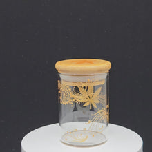 Load and play video in Gallery viewer, Stash Jar. Hand painted weed leaf with henna inspired art painted in gold. Airtight, straight sided, portable nug jar

