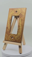 Load and play video in Gallery viewer, Hand Painted Cherry wood Switch / Cover / Wall plate for Paddle switch or decora outlet -Midsized. Gold henna inspired designs on solid wood.
