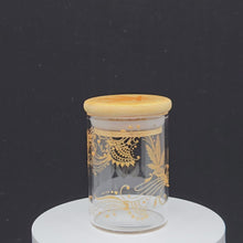 Load and play video in Gallery viewer, Stash Jar. Hand painted weed leaf with henna inspired art painted in gold. Airtight, straight sided, portable nug jar
