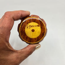 Load image into Gallery viewer, Medium size 4 part Herb Grinder with Kief catcher. Hand painted Studio 1 logo on imitation wood. Sharp teeth, magnetic closure with smooth grinding
