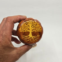 Load image into Gallery viewer, Medium size 4 part Herb Grinder with Kief catcher. Hand painted tree of life on imitation wood. Sharp teeth, magnetic closure with smooth grinding
