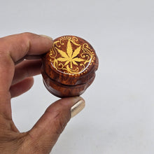 Load image into Gallery viewer, Mini/ tiny 4 part Herb Grinder with Kief catcher. Hand painted weed leaf on imitation wood. Sharp teeth, magnetic closure with smooth grinding
