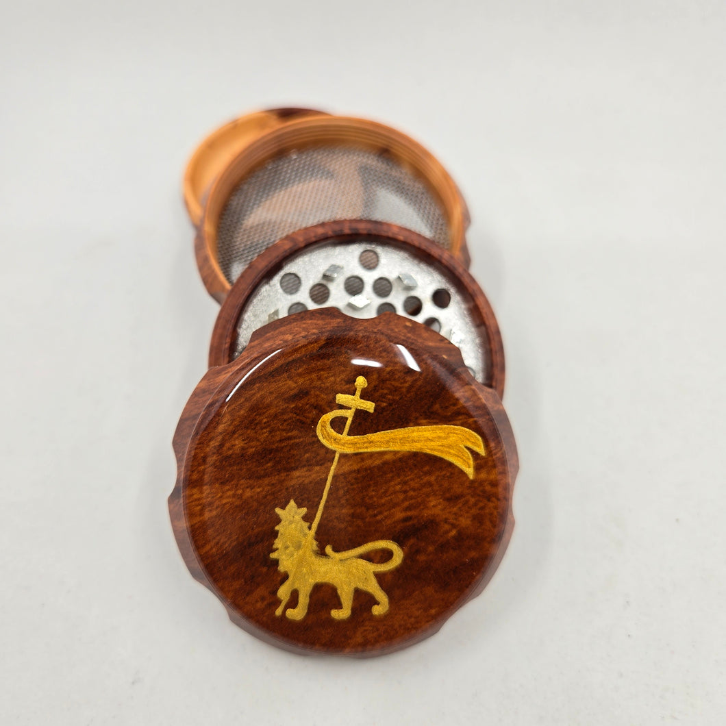 Medium size 4 part Herb Grinder with Kief catcher. Hand painted lion of Judah on imitation wood. Sharp teeth, magnetic closure with smooth grinding